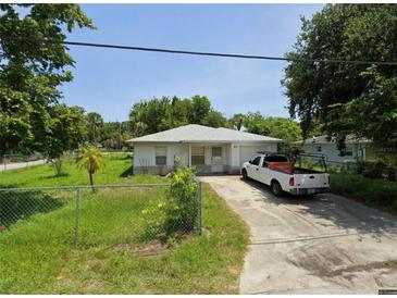 Ranch-style home with a yard and driveway at 451 Arthur Ave, Daytona Beach, FL 32114