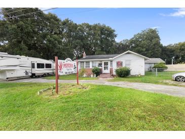 Cute bungalow-style home with RV parking and a psychic shop at 2480 N Woodland Blvd, Deland, FL 32720
