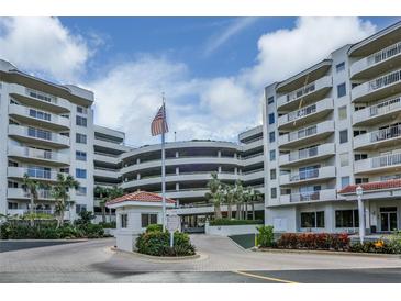 Exterior view of a condo building with parking and landscaping at 3 Oceans West Blvd # 4A5, Daytona Beach Shores, FL 32118