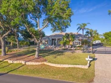 Stunning two-story home with lush landscaping and gated entrance at 3765 John Anderson Dr, Ormond Beach, FL 32176
