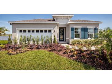 Single-story home with two-car garage and landscaped yard at 5769 Anders Way, St Cloud, FL 34771