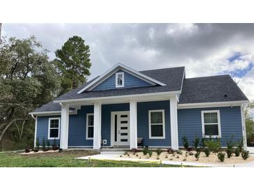 Blue house with white trim and landscaping at 34 Jackson Cir, Winter Springs, FL 32708