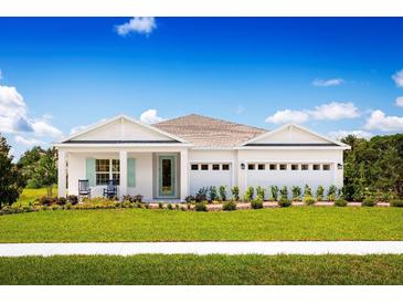 One-story home with white exterior, landscaping, and two-car garage at 7416 Sw 107Th Ln, Ocala, FL 34476