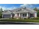 Craftsman style home with gray siding, red shutters, and stone accents at 1341 Arklow Cir, Ormond Beach, FL 32174