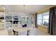 Bright dining room with a large window and modern chandelier at 1341 Arklow Cir, Ormond Beach, FL 32174