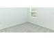 Simple bedroom with grey carpet and a window at 178 Jones Fish Camp Rd, Edgewater, FL 32141