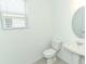 Simple bathroom with pedestal sink and oval mirror at 178 Jones Fish Camp Rd, Edgewater, FL 32141