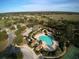 Community pool and tennis courts with surrounding landscape at 33953 Terragona Dr, Sorrento, FL 32776