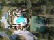 Aerial view of community pool, tennis courts, and clubhouse at 33953 Terragona Dr, Sorrento, FL 32776