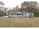 White single-story house with covered porch and large yard at 17336 N Highway 329, Reddick, FL 32686