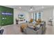 Spacious living room with gray sectional sofa, a large TV, and a green wall at 2201 Lelani Cir, Davenport, FL 33897