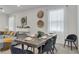Bright dining area with a gray table and six chairs, and a modern chandelier at 2201 Lelani Cir, Davenport, FL 33897