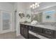 Double vanity bathroom with granite countertops and modern fixtures at 2201 Lelani Cir, Davenport, FL 33897