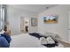 King sized bed, en-suite bathroom access, and a mounted TV at 2201 Lelani Cir, Davenport, FL 33897