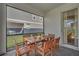 Screened patio with wooden dining table and chairs at 2201 Lelani Cir, Davenport, FL 33897