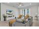 Spacious living room with gray sectional sofa, a large TV, and a green wall at 2201 Lelani Cir, Davenport, FL 33897