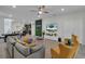 Open concept living room with sectional sofa and view into kitchen and dining area at 2201 Lelani Cir, Davenport, FL 33897