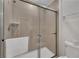 Shower with glass sliding doors and neutral tile at 2201 Lelani Cir, Davenport, FL 33897