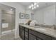 Double vanity bathroom with granite countertop and shower at 2201 Lelani Cir, Davenport, FL 33897