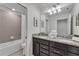 Double vanity bathroom with granite countertop and shower/tub combo at 2201 Lelani Cir, Davenport, FL 33897