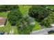 Aerial view of a house nestled among lush green trees at 15 N Bloxham Ave, Fort Meade, FL 33841