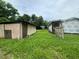 Overgrown backyard with a small shed and tall grass at 1134 N Davis Ave, Lakeland, FL 33805