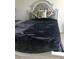 Bedroom with gray bedding and ornate headboard at 177 Bella Verano Way, Davenport, FL 33897