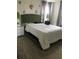 Cozy bedroom with green headboard and white bedding at 177 Bella Verano Way, Davenport, FL 33897