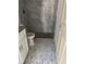 Clean bathroom with grey tile shower and patterned floor at 714 Nw 1St St, Ocala, FL 34482