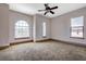 Bright bedroom featuring arched windows and wall-to-wall carpet at 779 Stephens Pass Cv, Lake Mary, FL 32746