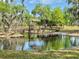 Picturesque wooden bridge over a calm pond with a gazebo at 850 Eden Dr, Saint Cloud, FL 34771