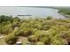 Aerial view showcasing a home nestled in a wooded area near a lake at 850 Eden Dr, Saint Cloud, FL 34771