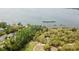 Aerial view of waterfront property with houses and lush vegetation at 850 Eden Dr, Saint Cloud, FL 34771