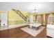 Living room with hardwood floors, a white sofa and stairs leading upstairs at 11407 Bentry St, Orlando, FL 32824