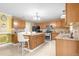 Kitchen boasts granite counters, wood cabinets, and an island with seating at 11407 Bentry St, Orlando, FL 32824