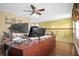 Home office features a large desk, dual monitors, and hardwood floors at 11407 Bentry St, Orlando, FL 32824