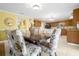 Dining room with floral-patterned chairs and a view of the kitchen at 11407 Bentry St, Orlando, FL 32824