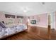 Bright bedroom featuring a king-size bed and wood floors at 11407 Bentry St, Orlando, FL 32824