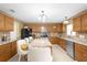 Open kitchen with granite counters, wood cabinets & island at 11407 Bentry St, Orlando, FL 32824