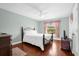 Cozy bedroom with a double bed, hardwood floors, and ceiling fan at 11407 Bentry St, Orlando, FL 32824