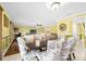 Dining room with floral-patterned chairs and a view into the living room at 11407 Bentry St, Orlando, FL 32824