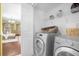 Laundry room with washer, dryer, and shelving at 11407 Bentry St, Orlando, FL 32824
