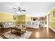 Bright living room with hardwood floors, beige sofas, and a view of the kitchen at 11407 Bentry St, Orlando, FL 32824
