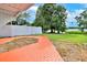 Brick pathway leads to a tranquil backyard overlooking the lake at 1502 Ne Buckeye Ne Rd # 2, Winter Haven, FL 33881