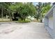 Community entrance with lush landscaping and trees at 1502 Ne Buckeye Ne Rd # 2, Winter Haven, FL 33881