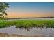 Stunning sunset view over calm lake waters and lush landscape at 1502 Ne Buckeye Ne Rd # 2, Winter Haven, FL 33881