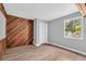 Bright bedroom with wood-paneled wall and new flooring at 1502 Ne Buckeye Ne Rd # 2, Winter Haven, FL 33881