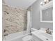 Clean bathroom with marble-patterned shower/tub combo at 1502 Ne Buckeye Ne Rd # 2, Winter Haven, FL 33881