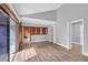 Open living area with wood floors and access to other rooms at 1502 Ne Buckeye Ne Rd # 2, Winter Haven, FL 33881