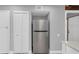 Kitchen area with stainless steel refrigerator and white shaker cabinets at 1502 Ne Buckeye Ne Rd # 2, Winter Haven, FL 33881